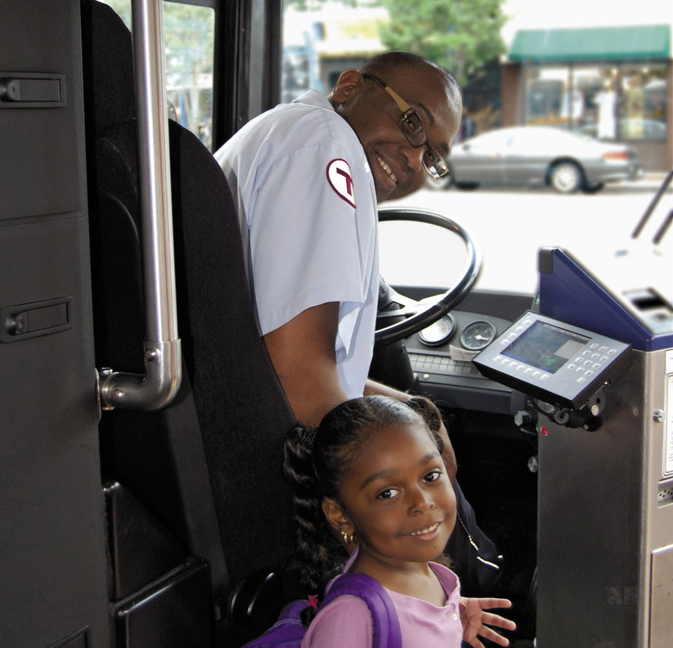 A picture of an MBTA bus employee with a customer.