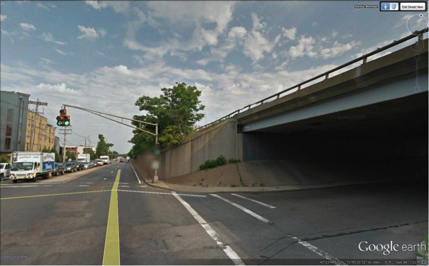 FIGURE 15. Embankment Approaching Interchange 28/Sullivan Square Exit, View Looking North from Mystic Avenue
Figure 15 contains a color photograph of the above-cited location.