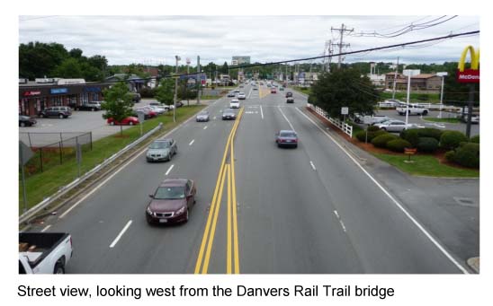 Image shows the street view, looking west from the Danvers Rail Trail bridge