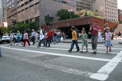 Description: Picture of pedestrians crossing Congress Street in downtown Boston.